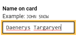 The spellcheck underlines the name: Daenerys Targaryen entered in an input box for a name on a credit card payment form.